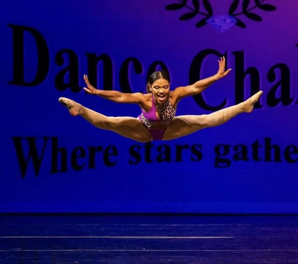 Dancer in straddle leap on stage
